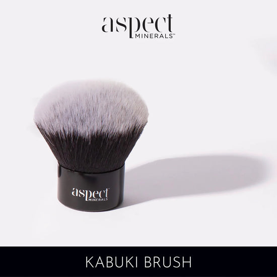 Aspect Minerals Kabuki Brush, soft dense bristles with a sleek black handle, compact for applying loose mineral powders.