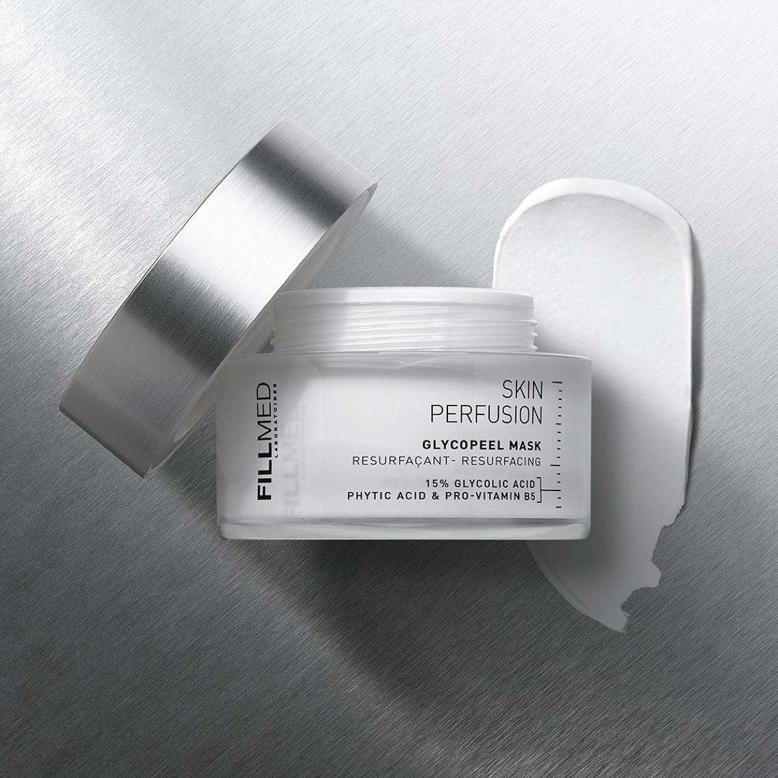 FIllmed glycopeel mask in clear jar with silver lid opened, white cream product swatch